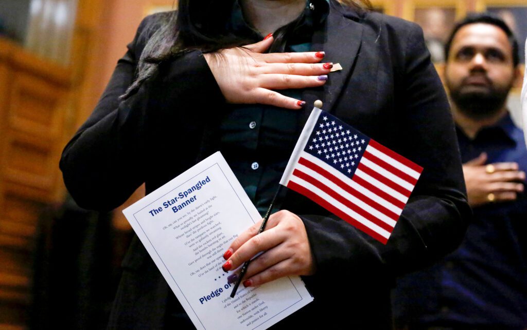 Candidates for US citizenship take the oath of allegiance during a Naturalization Ceremony for new US citizens at the City Hall of Jersey City in New Jersey on February 22, 2017. / AFP / KENA BETANCUR        (Photo credit should read KENA BETANCUR/AFP/Getty Images)