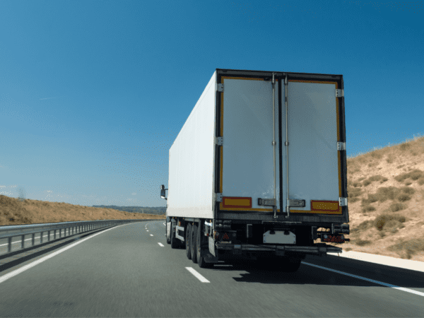 Back side view of a big rig on the highway